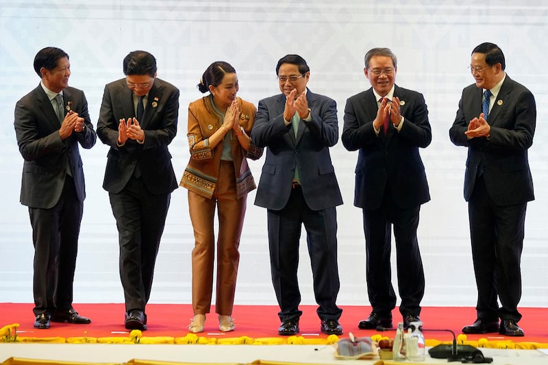 From left, Philippine's President Ferdinand Marcos Jr., Singapore's Prime Minister Lawrence Wong, Thailand's Prime Minister Paetongtarn Shinawatra, Vietnam's Prime Minister Pham Minh Chinh, Chinese Premier Li Qiang and Laos' Prime Minister Sonexay Siphandone applaud after a group photo session during the ASEAN-China Summit in Vientiane, Oct. 10, 2024. (Dita Alangkara/AP)