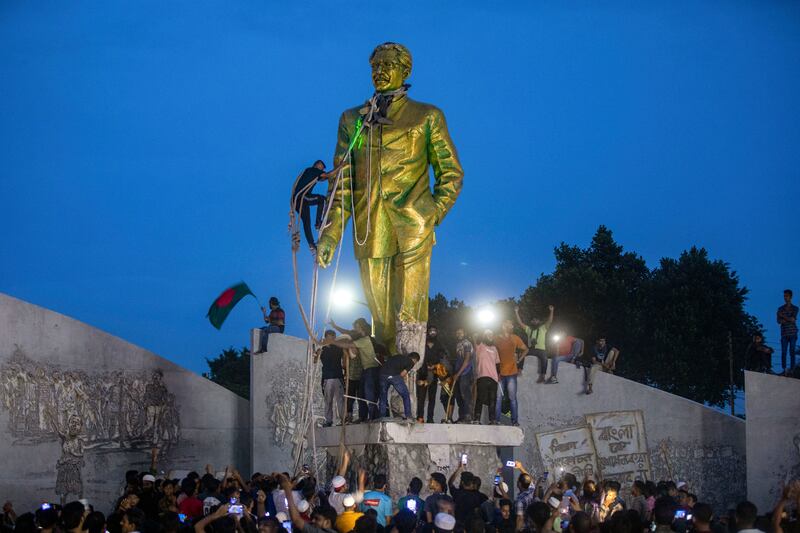 Protesters try to demolish a large statue of Sheikh Mujibur Rahman, father of Bangladesh leader Sheikh Hasina and the nation's founding leader, after she resigned as prime minister, in Dhaka, Aug. 5, 2024. (Rajib Dhar/AP)